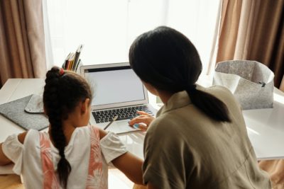 Child And Mother Doing Homework